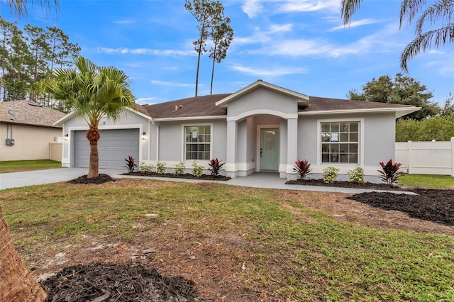 single story home featuring a garage, a front yard, concrete driveway, and stucco siding