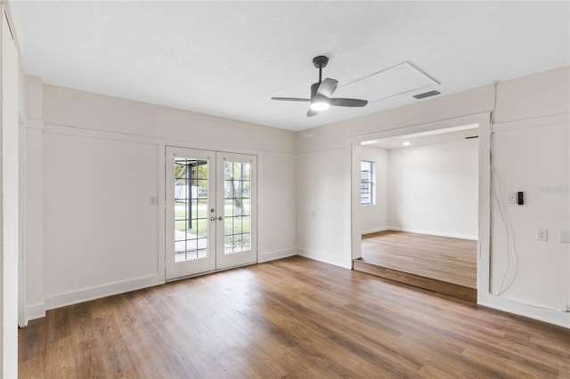 interior space featuring french doors, wood finished floors, visible vents, and baseboards