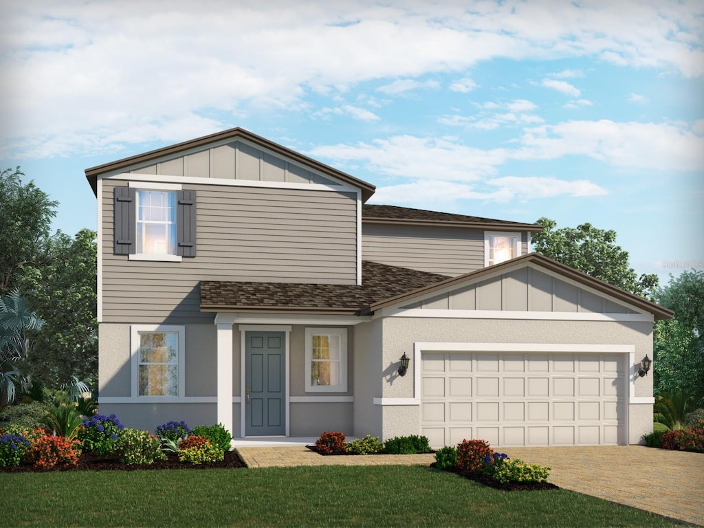 view of front of home featuring a garage, driveway, a shingled roof, board and batten siding, and a front yard