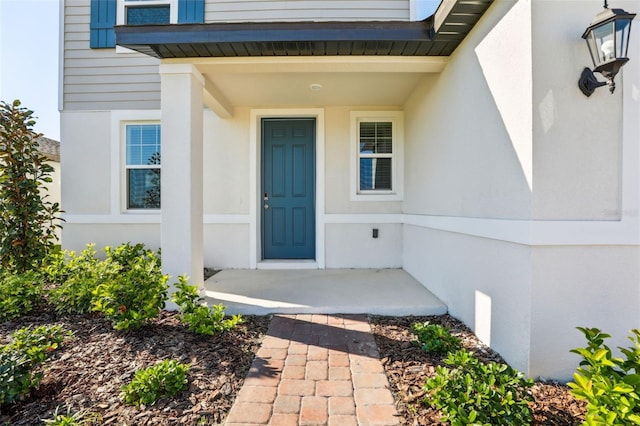 entrance to property featuring stucco siding