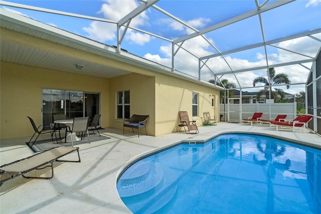 view of swimming pool with a fenced in pool, a lanai, a patio area, and fence