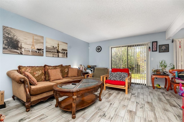 living area featuring a textured ceiling and light wood-style flooring