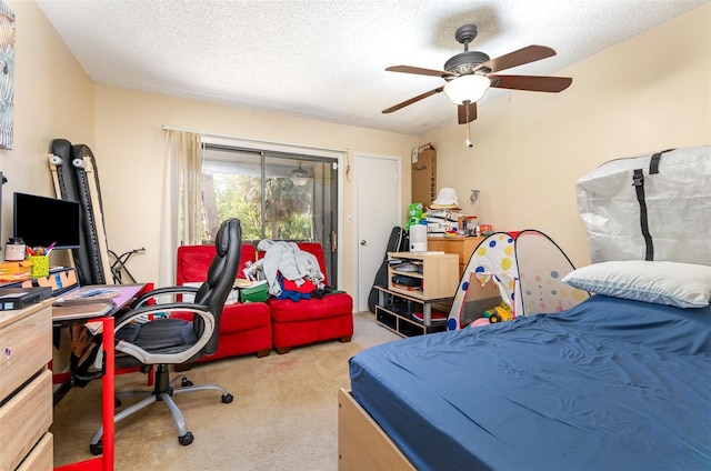 carpeted bedroom with a textured ceiling and ceiling fan