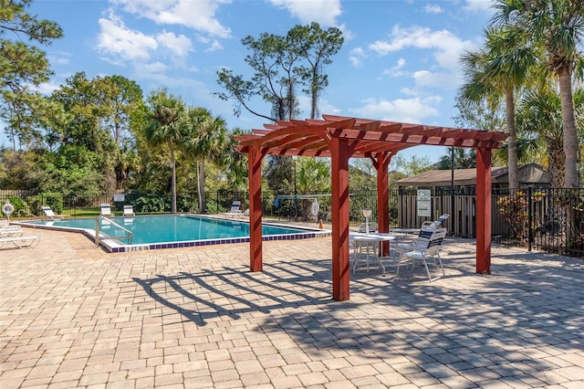 community pool featuring fence, a pergola, and a patio