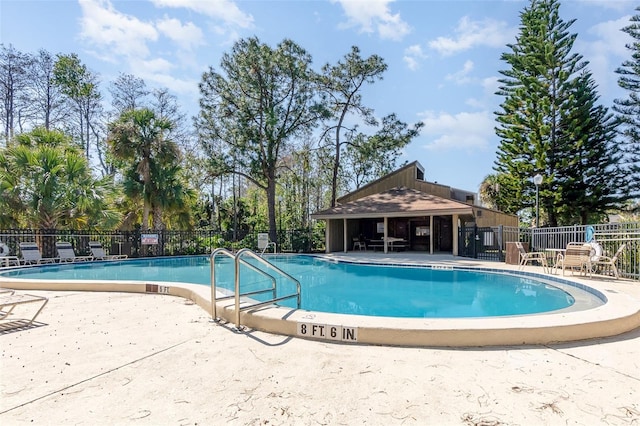 pool featuring a patio area and fence