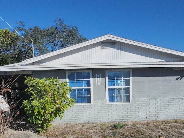 view of side of property featuring brick siding