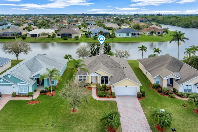 drone / aerial view featuring a residential view and a water view