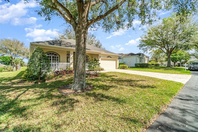 ranch-style house featuring covered porch, concrete driveway, a front lawn, and stucco siding