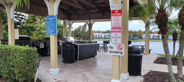 view of patio / terrace with a water view and grilling area