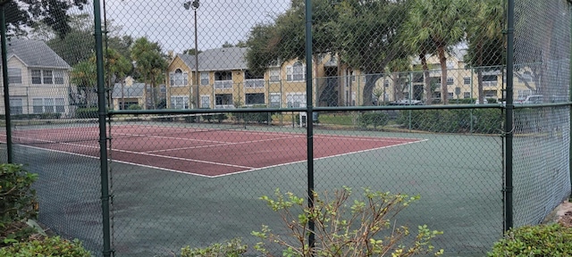 view of sport court with fence