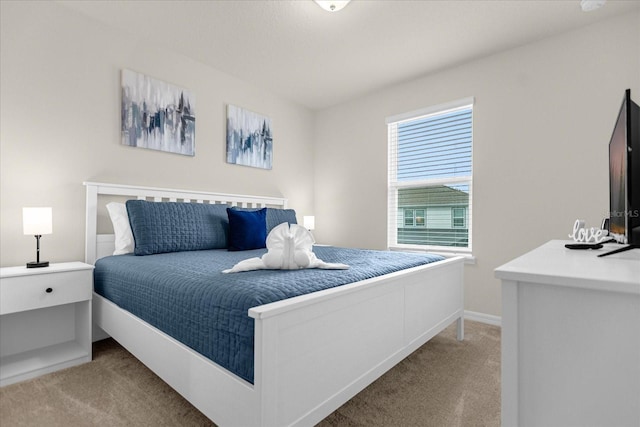 bedroom featuring carpet flooring and baseboards