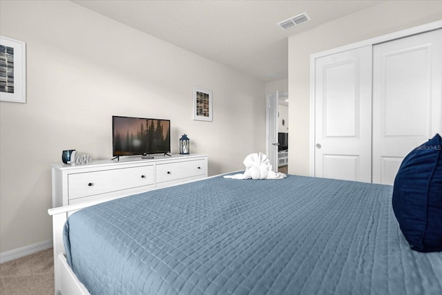 carpeted bedroom featuring baseboards, visible vents, and a closet