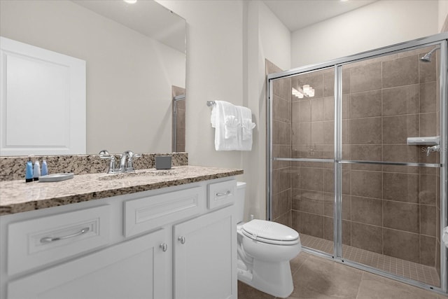 full bathroom featuring toilet, tile patterned flooring, vanity, and a shower stall