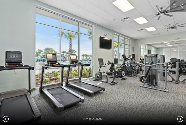 gym with ceiling fan, visible vents, and floor to ceiling windows