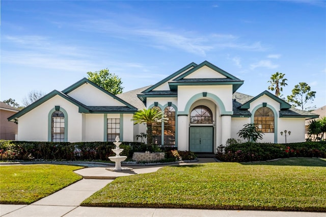 view of front of property featuring a front lawn and stucco siding