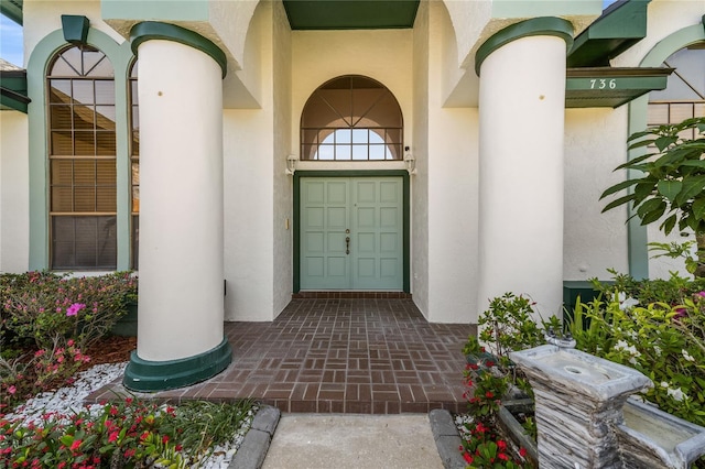 property entrance with stucco siding