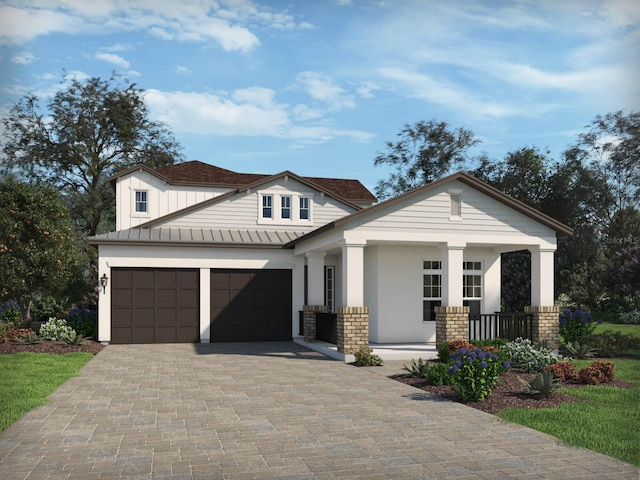 view of front of house featuring a standing seam roof, metal roof, brick siding, and decorative driveway