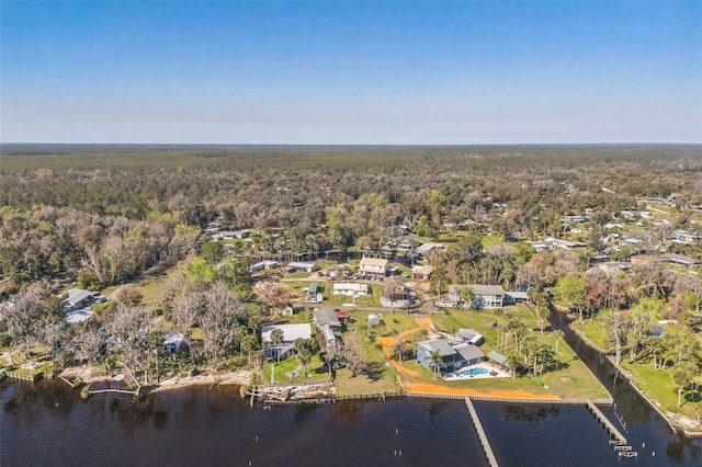 bird's eye view with a water view and a wooded view