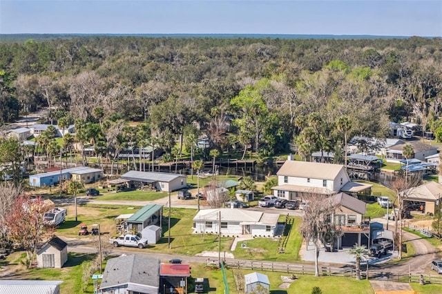 drone / aerial view with a residential view and a view of trees