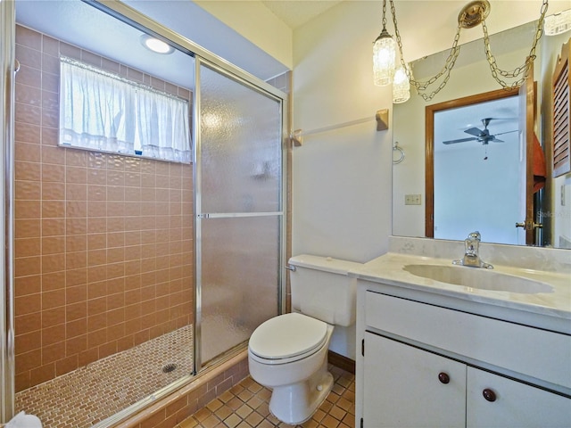 bathroom with a stall shower, tile patterned flooring, vanity, and toilet