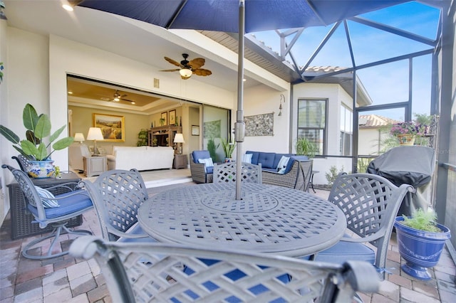 view of patio / terrace with an outdoor hangout area, ceiling fan, outdoor dining area, and a lanai