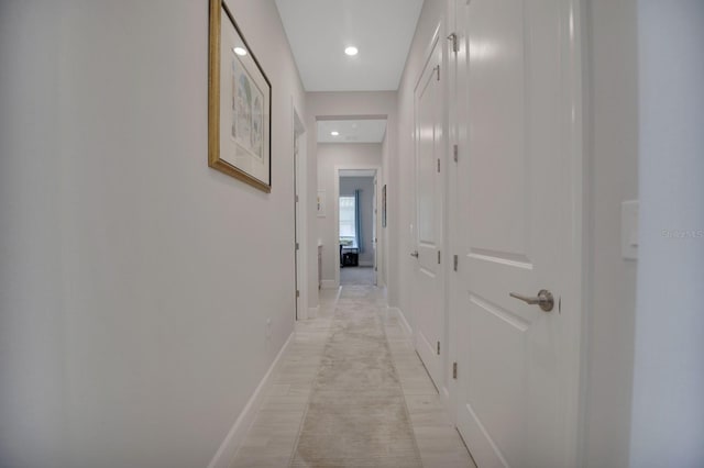 corridor featuring baseboards and recessed lighting