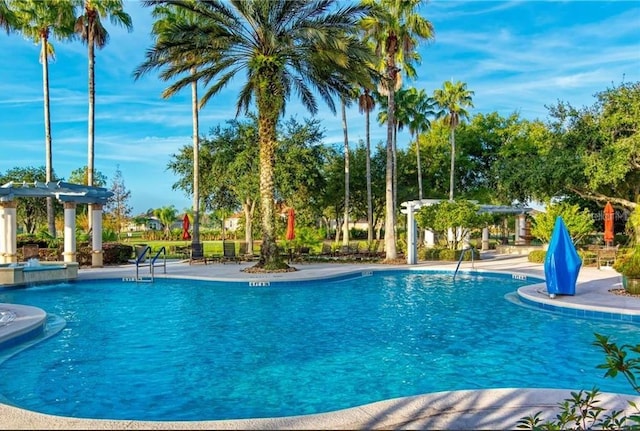 pool with a pergola and a patio