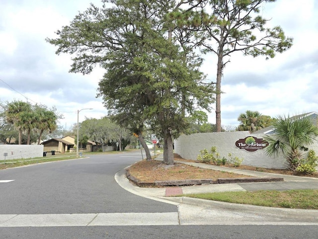 view of road with street lights, curbs, and sidewalks