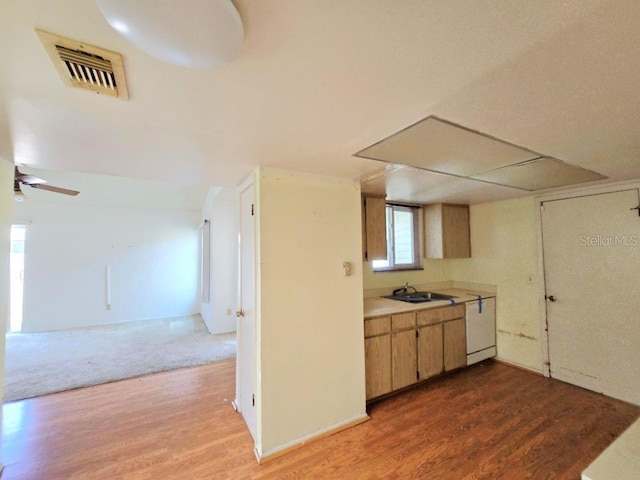 kitchen featuring open floor plan, light countertops, visible vents, and wood finished floors