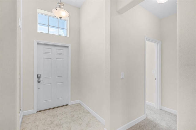 entrance foyer featuring light tile patterned floors and baseboards