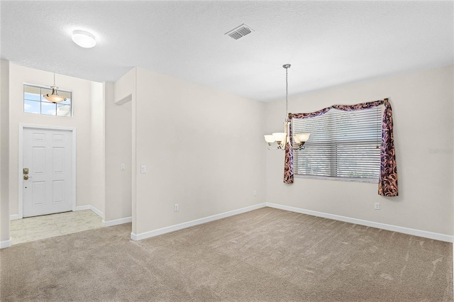 interior space with a chandelier, a wealth of natural light, a textured ceiling, and baseboards