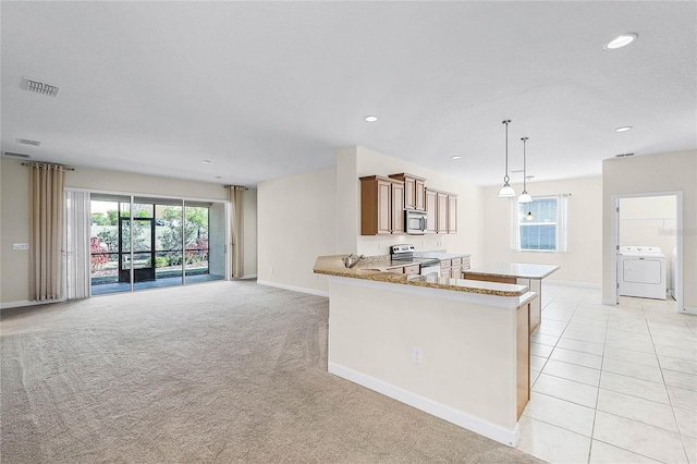 kitchen featuring washer / clothes dryer, light colored carpet, visible vents, appliances with stainless steel finishes, and baseboards