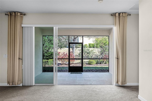 entryway featuring carpet, visible vents, and baseboards