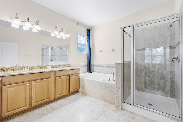 bathroom with a textured ceiling, a garden tub, tile patterned floors, double vanity, and a stall shower