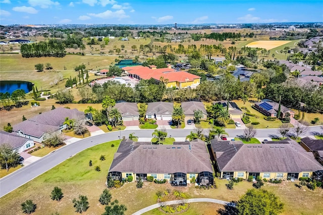 drone / aerial view with a water view and a residential view