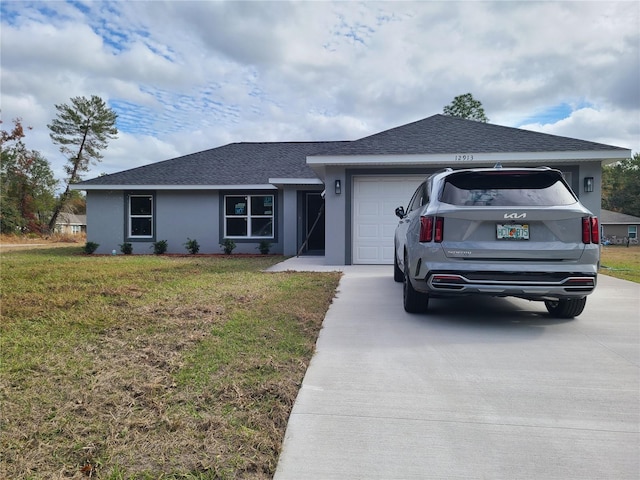 ranch-style house featuring a garage, a shingled roof, driveway, stucco siding, and a front yard