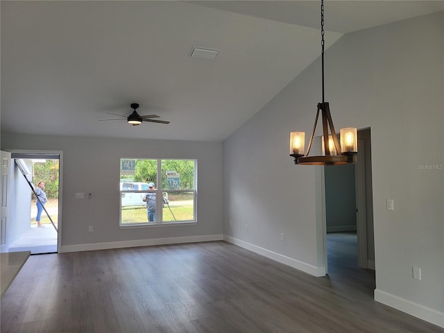 unfurnished room featuring dark wood-type flooring, lofted ceiling, visible vents, and plenty of natural light