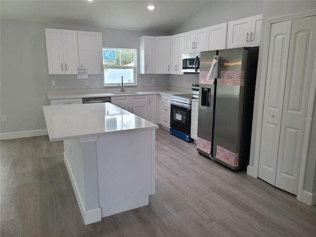 kitchen featuring white cabinetry, a kitchen island, and appliances with stainless steel finishes