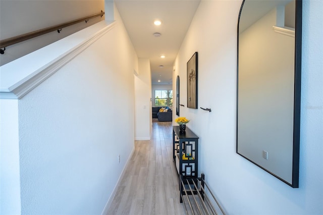 hall featuring recessed lighting, baseboards, and light wood finished floors