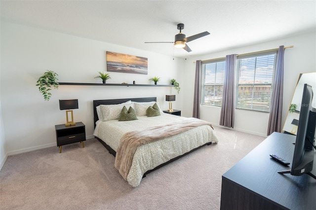 bedroom with a ceiling fan, carpet, and baseboards