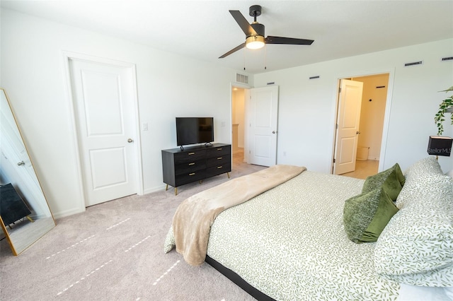 carpeted bedroom featuring a ceiling fan, visible vents, and baseboards