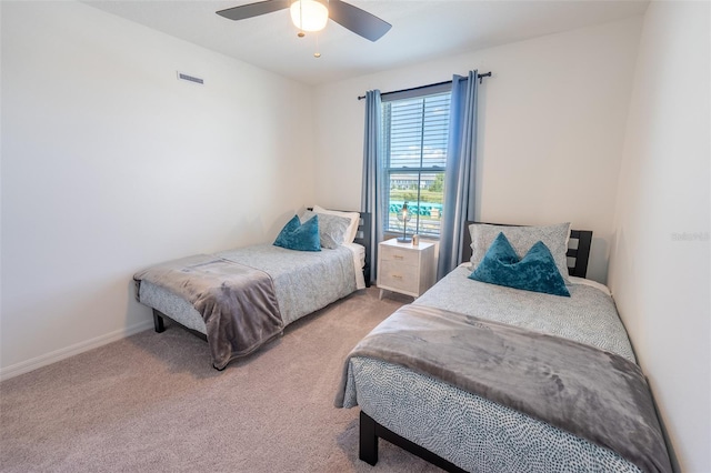 bedroom with light carpet, baseboards, visible vents, and a ceiling fan