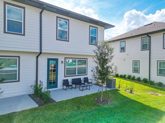 back of house featuring a patio area, central AC unit, and a yard