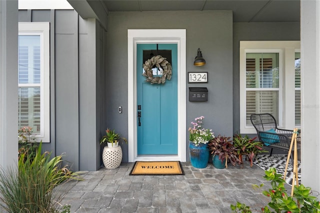 property entrance featuring a porch and board and batten siding