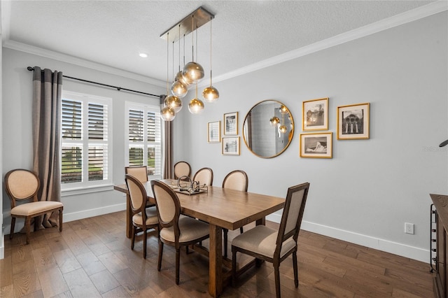 dining space featuring a textured ceiling, ornamental molding, dark wood-style flooring, and baseboards