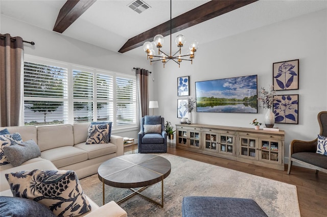 living area with visible vents, a chandelier, beamed ceiling, and wood finished floors