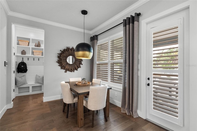 dining room featuring baseboards, wood finished floors, and crown molding