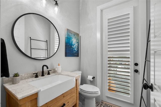 half bathroom featuring toilet and vanity