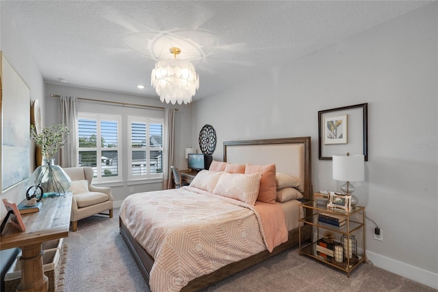 carpeted bedroom with an inviting chandelier, baseboards, and a textured ceiling