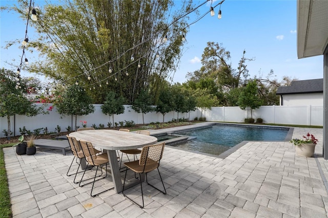 view of swimming pool with outdoor dining space, a fenced backyard, and a patio